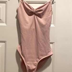 Light pink Yumiko leotard. Adult Small. High leg. Bust lining. Pinch front.